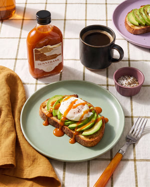 Sunnybank pineapple and habanero hot sauce drizzled over avocado toast with a poached egg.