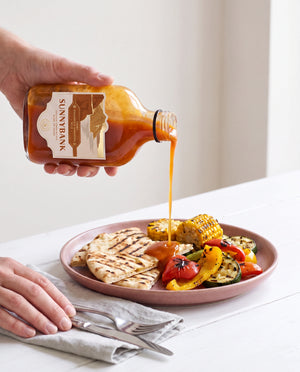 Sunnybank pineapple and habanero hot sauce poured over grilled chicken, corn and vegetables.