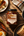 Jar of Sunnybank chilli crisp oil beside baked beans, fried egg and toast on a wooden breakfast table.