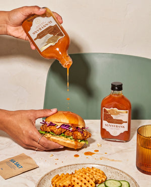 Sunnybank pineapple and habanero hot sauce drizzled onto a crispy chicken burger, with waffle fries.